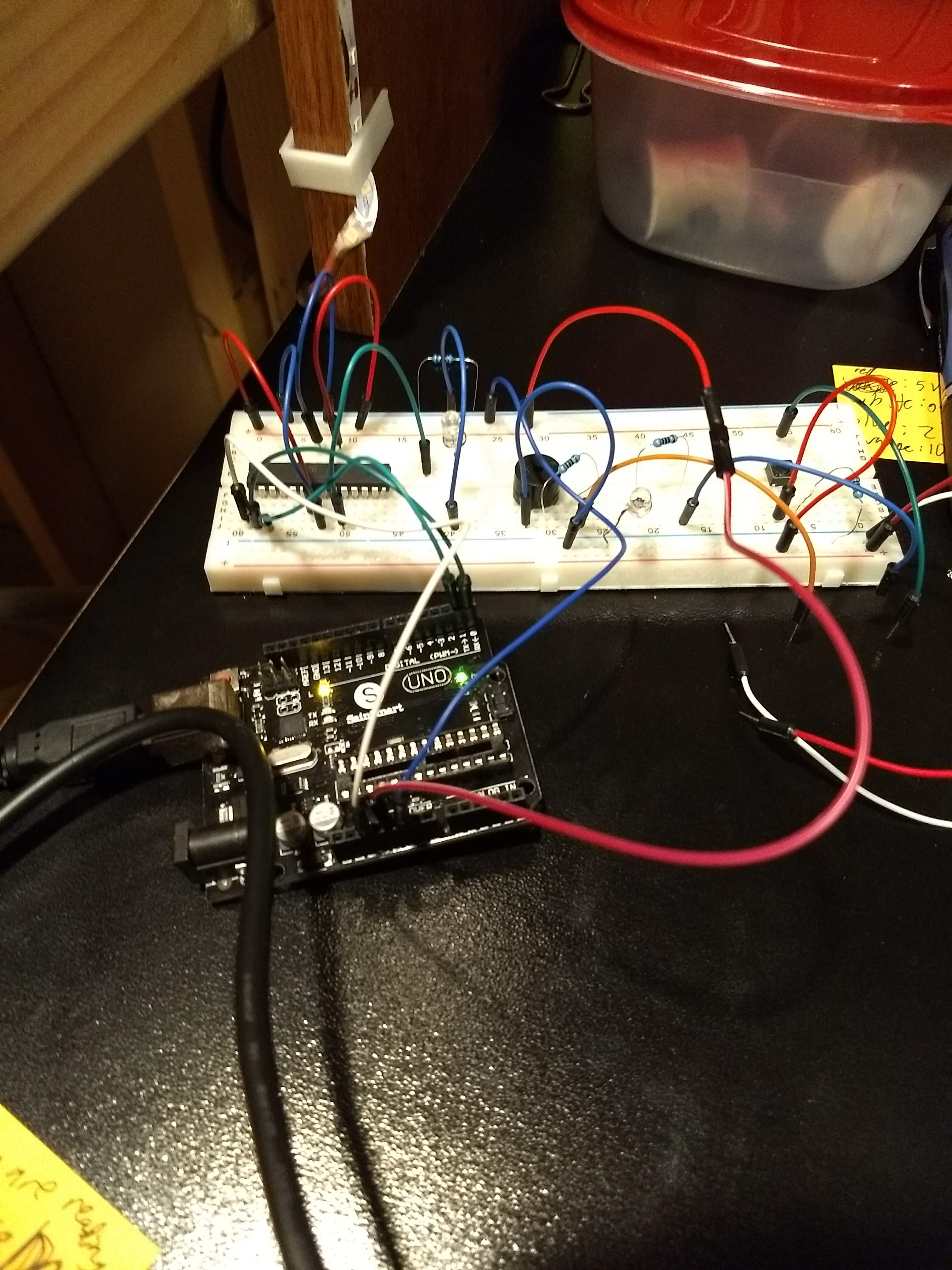 The wiring layed out on a breadboard with the microcontroller being programmed by an Arduino Uno board